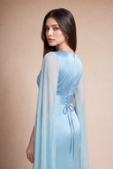 Mariya aquatic blue evening gown — over-shoulder back portrait showing the corset lace-up and cape sleeve, Mystic Modesty