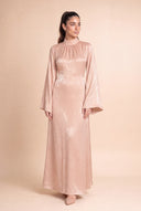Editorial portrait of model in the Mystic Modesty Camille beige modest evening dress with wide bell sleeves