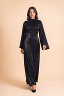 Model walking in the Camille black velvet evening dress with long sleeves