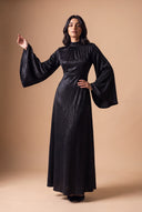 Wide bell sleeve of the Camille black velvet evening dress, editorial pose