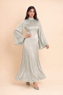 Skirt of the Camille sage green velvet dress flowing in motion