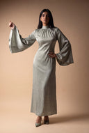 Wide bell sleeve of the Camille light green velvet evening dress, editorial pose