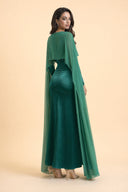 Chiffon Dream Modest Evening Dress in Emerald Green — three-quarter back angle with gentle over-shoulder glance — modeled without hijab — modest evening fashion for all — Mystic Modesty modest formal wear for women.