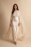 Mystic Modesty Chiffon Dream soft beige modest evening dress in motion, flowing chiffon cape mid-stride, floor-length satin