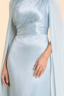 Modest Luxe Satin Evening Gown in Aquatic Blue — mid-body view showing waist construction and elegant jewelry detail — modeled without hijab — modest evening fashion for all — Mystic Modesty modest occasion gown.