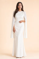 Modest Luxe Satin Evening Gown in Ivory White — editorial quiet moment, contemplative pose — modeled without hijab — modest evening fashion for all — Mystic Modesty modest evening dress.