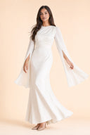 Modest Luxe Satin Evening Gown in Ivory White — captured in natural stride showing fabric flow and movement — modeled without hijab — modest evening fashion for all — Mystic Modesty modest evening fashion.