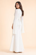 Modest Luxe Satin Evening Gown in Ivory White — three-quarter back angle with gentle over-shoulder glance — modeled without hijab — modest evening fashion for all — Mystic Modesty modest formal wear for women.