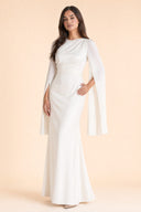 Modest Luxe Satin Evening Gown in Ivory White — three-quarter front angle showing dimensional drape and silhouette — modeled without hijab — modest evening fashion for all — Mystic Modesty modest evening gown collection.