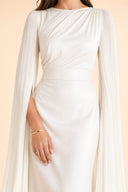 Modest Luxe Satin Evening Gown in Ivory White — mid-body view showing waist construction and elegant jewelry detail — modeled without hijab — modest evening fashion for all — Mystic Modesty modest occasion gown.