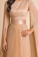 Modest Pleated Satin Gown in Champagne Cream — mid-body view showing waist construction and elegant jewelry detail — modeled without hijab — modest evening fashion for all — Mystic Modesty modest occasion gown.