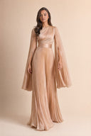 Modest Pleated Satin Gown in Champagne Cream — walking lifestyle shot, confident and graceful arrival — modeled without hijab — modest evening fashion for all — Mystic Modesty hijabi-friendly evening wear.