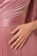 Modest Pleated Satin Gown in Dusty Rose — ultra-macro detail of premium fabric texture, sheen, and refined jewelry — modeled without hijab — modest evening fashion for all — Mystic Modesty premium modest evening wear.