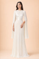 Modest Pleated Satin Gown in Ivory White — editorial quiet moment, contemplative pose — modeled without hijab — modest evening fashion for all — Mystic Modesty modest evening dress.