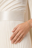Modest Pleated Satin Gown in Ivory White — ultra-macro detail of premium fabric texture, sheen, and refined jewelry — modeled without hijab — modest evening fashion for all — Mystic Modesty premium modest evening wear.