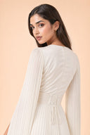 Modest Pleated Satin Gown in Ivory White — over-shoulder back profile portrait, intimate editorial close-up — modeled without hijab — modest evening fashion for all — Mystic Modesty premium hijab fashion brand.
