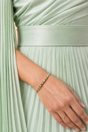 Modest Pleated Satin Gown in Mint Green — ultra-macro detail of premium fabric texture, sheen, and refined jewelry — modeled without hijab — modest evening fashion for all — Mystic Modesty premium modest evening wear.
