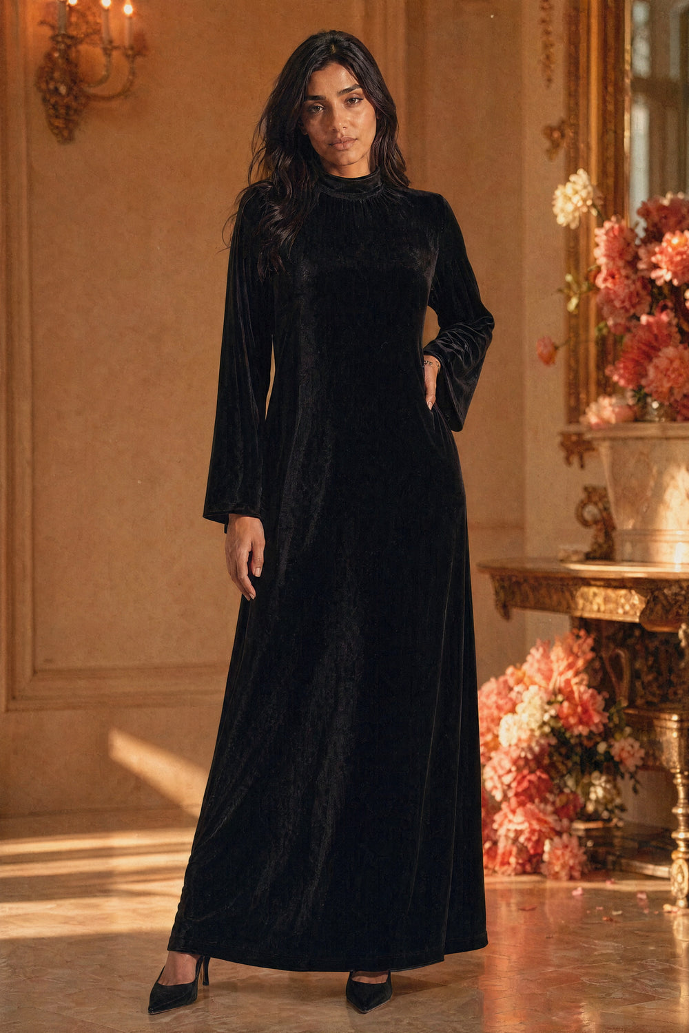 Mystic Modesty SS26— Camille Black velvet gown, studio portrait against cream backdrop with coral peonies, non-hijabi model, modest evening wear, Vogue editorial film aesthetic