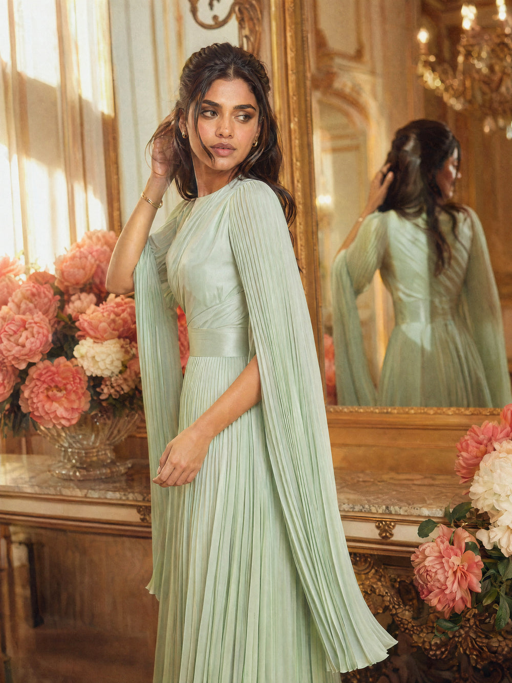 Mystic Modesty SS26— Saffira Mint pleated satin, intimate dressing-room moment with gilded mirror reflection, modest evening wear, Vogue editorial film aesthetic