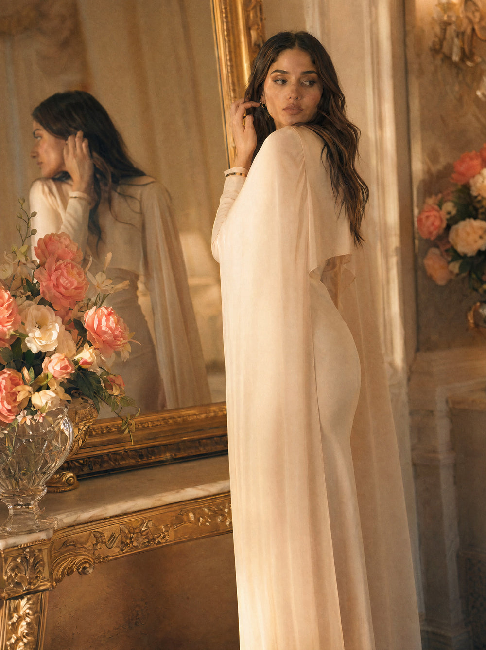 Mystic Modesty SS26— Yasmine Beige chiffon cape gown, intimate dressing-room moment with gilded mirror reflection, modest evening wear, Vogue editorial film aesthetic