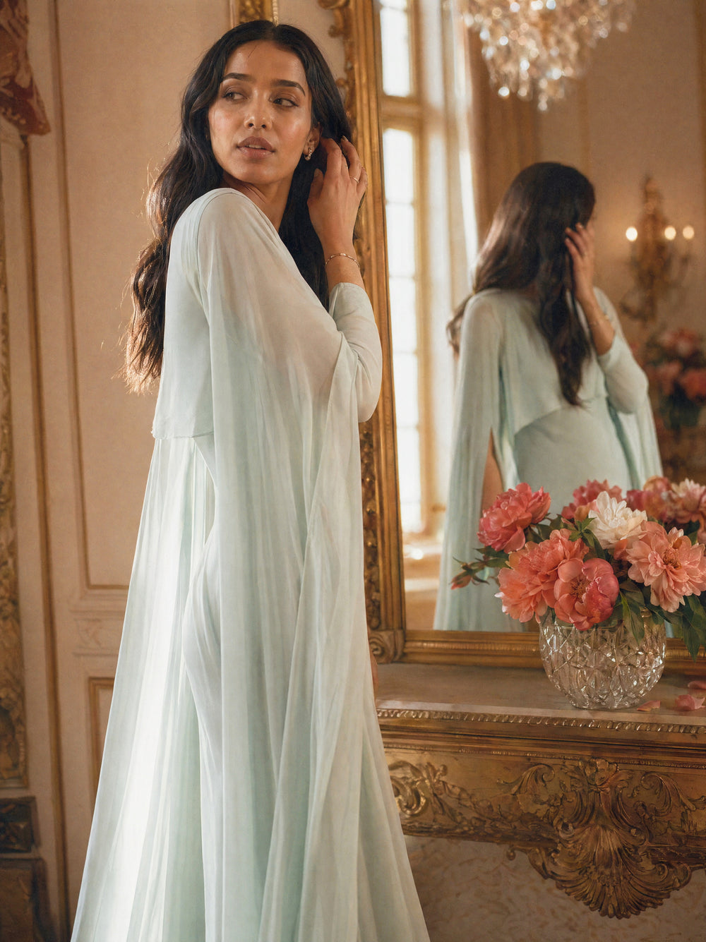 Mystic Modesty SS26— Yasmine Mint chiffon cape gown, intimate dressing-room moment with gilded mirror reflection, modest evening wear, Vogue editorial film aesthetic