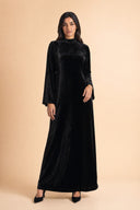 Velvet Elegance Modest Abaya Dress in Deep Black — full-body front view of the dress — modeled without hijab — modest evening fashion for all — Mystic Modesty modest occasion wear.