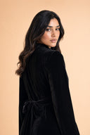 Velvet Elegance Modest Abaya Dress in Deep Black — over-shoulder back profile portrait, intimate editorial close-up — modeled without hijab — modest evening fashion for all — Mystic Modesty premium hijab fashion brand.