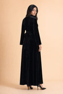Velvet Elegance Modest Abaya Dress in Deep Black — three-quarter back angle with gentle over-shoulder glance — modeled without hijab — modest evening fashion for all — Mystic Modesty modest formal wear for women.