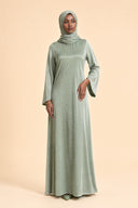 Velvet Elegance Modest Abaya Dress in Forest Green — editorial quiet moment, contemplative pose — modeled with hijab — Islamic modest styling — Mystic Modesty hijabi-friendly evening wear.