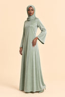 Velvet Elegance Modest Abaya Dress in Forest Green — three-quarter front angle showing dimensional drape and silhouette — modeled with hijab — Islamic modest styling — Mystic Modesty hijab fashion modest gown.