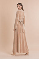 Velvet Elegance Modest Abaya Dress in Warm Beige — three-quarter back angle with gentle over-shoulder glance — modeled without hijab — modest evening fashion for all — Mystic Modesty modest formal wear for women.
